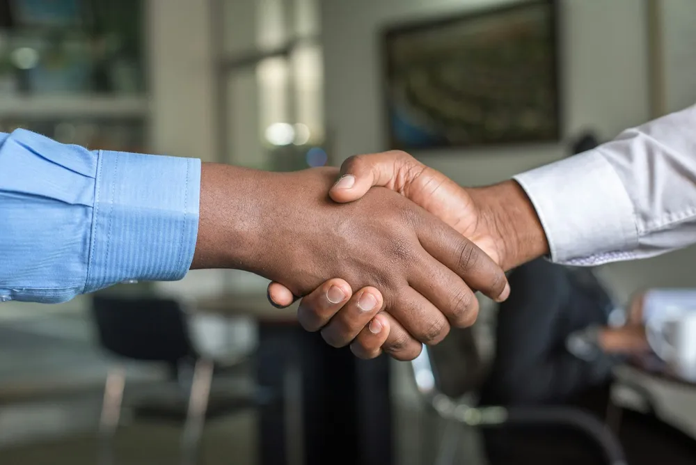 A PrimeCraft advisor shaking hands with a homeowner